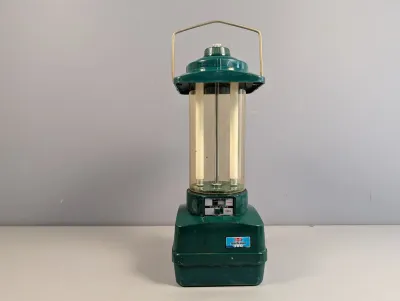 Sale Photo Thumbnail #193: Vintage Ray-O-Vac Sportsman 360 solid-state fluorescent camping lantern in green plastic casing with top wire handle.