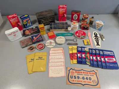 Sale Photo Thumbnail #434: Collection of vintage advertising ephemera, tins, and small collectibles, including a Romper Room license plate, Lysol boxes, Band-Aid tins, and tobacco packets.