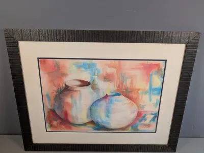 Sale Photo Thumbnail #442: Framed watercolor print depicting Southwestern-style pottery vessels in pastel tones, presented with a wide double mat and a dark textured wooden frame.
