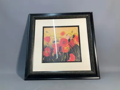 Sale Photo Thumbnail #151: Framed floral print depicting vibrant red poppies, set in an off-white mat and a dark molded frame with rope-twist details.