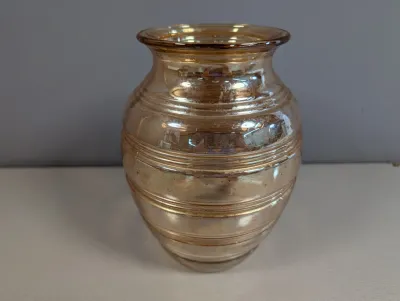 Sale Photo Thumbnail #190: Vintage marigold carnival glass vase featuring horizontal raised ribbed bands.
