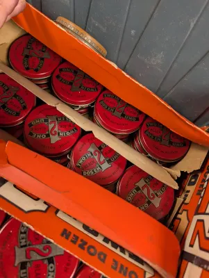 Sale Photo Thumbnail #375: Vintage box filled with red tins of 2in1 Black Shoe Polish.