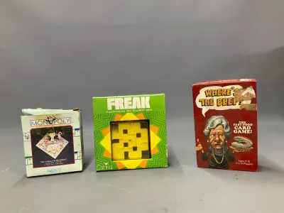 Sale Photo Thumbnail #323: Collection of vintage games and novelty items, including Enesco Monopoly ornament in box, Gabriel Freak puzzle game, and Milton Bradley Where's The Beef? card game.