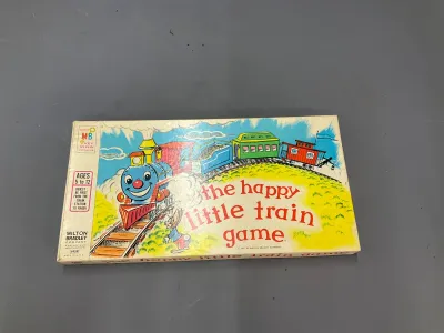 Sale Photo Thumbnail #324: Vintage 1957 Milton Bradley 'The Happy Little Train Game' in original box, featuring colorful train artwork.