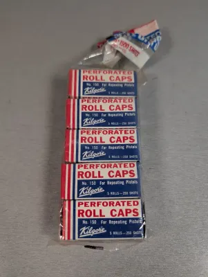 Sale Photo Thumbnail #311: Unopened vintage package of five Kilgore No. 150 perforated roll caps for repeating toy pistols.