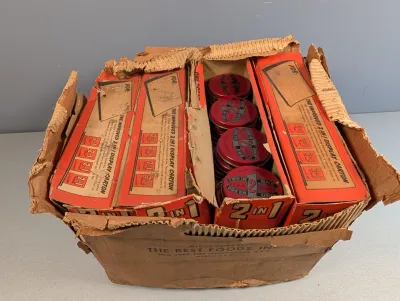 Sale Photo Thumbnail #238: Vintage cardboard shipping box filled with original display cartons and round red tins of 2 IN 1 Black shoe polish by The Best Foods, Inc.