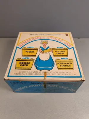 Sale Photo Thumbnail #189: Vintage Mother Hubbard's Remarkable Nature Jar set in its original illustrated cardboard box, showing light edge wear and tape residue.
