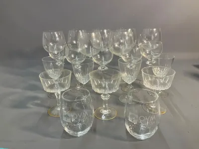 Sale Photo Thumbnail #90: Large collection of assorted crystal and glass drinkware, including wine stems, coupe glasses, and stemless tumblers in various cut and plain patterns.
