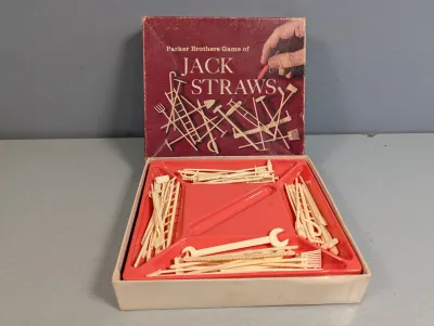 Sale Photo Thumbnail #229: Vintage Parker Brothers Game of Jack Straws with plastic tool-shaped pieces, plastic organizer tray, and original box lid.