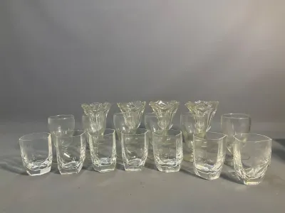 Sale Photo Thumbnail #52: Large collection of clear pressed glass tableware, including octagonal tumblers, footed goblets, and ruffled sundae dishes.