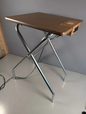 Sale Photo Thumbnail #420: Vintage folding TV tray table with woodgrain laminate top, tubular chrome legs, and built-in electronic control panel, circa 1970s.