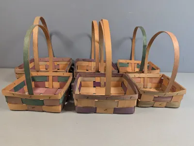 Sale Photo Thumbnail #220: Set of six handcrafted woven splint gathering baskets with fixed bentwood handles, featuring colorful dyed accents in green and purple.