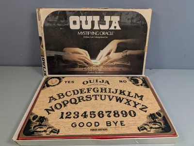 Sale Photo Thumbnail #221: Vintage Parker Brothers Ouija Mystifying Oracle talking board game in original box showing edge wear and tape repairs.