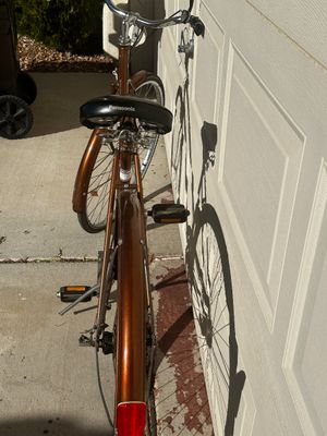 Sale Photo Thumbnail #12: Vintage Panasonic metallic copper cruiser bicycle, featuring original fenders, a sprung black Panasonic seat, and rear reflector.