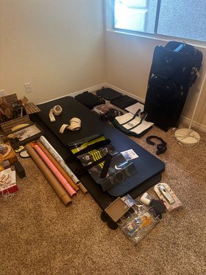 Sale Photo Thumbnail #74: Collection of household goods including a folding workout mat, rolls of wrapping paper, a golf bag, tote bags, and small misc accessories.