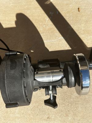 Sale Photo Thumbnail #7: Close-up of an indoor bicycle resistance trainer unit, featuring a metal roller mechanism and chrome flywheel.