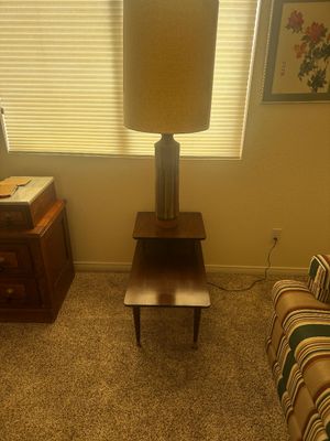 Sale Photo Thumbnail #36: Mid-century modern two-tier walnut step end table, topped with a tall ceramic lamp featuring a tall cylindrical shade.