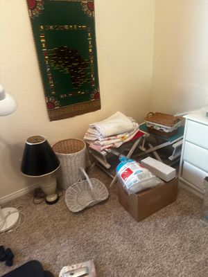 Sale Photo Thumbnail #76: Collection of bedroom items including folded linens on folding luggage racks, woven storage baskets, table lamp, and an African map wall tapestry.