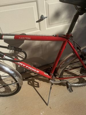 Sale Photo Thumbnail #17: Red Gary Fisher Tarpon mountain bike featuring silver fenders, kickstand, and attached bike lock.