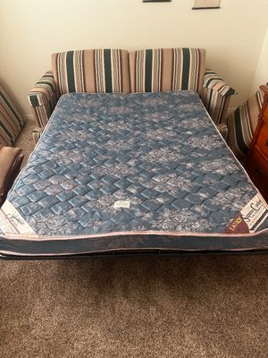 Sale Photo Thumbnail #42: La-Z-Boy Supreme Comfort sleeper sofa pulled out into a bed, featuring striped multi-color fabric upholstery and a blue floral quilted mattress.
