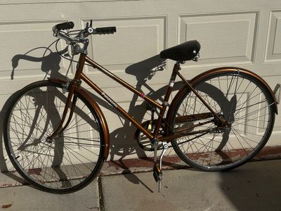 Sale Photo Thumbnail #13: Vintage bronze-tone Panasonic Tourist step-through 3-speed bicycle featuring matching fenders and a padded black seat.