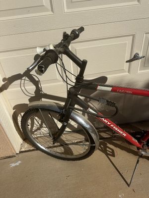 Sale Photo Thumbnail #16: Red Gary Fisher Tarpon mountain bike featuring silver fenders, a front bell, and an attached Kryptonite cable lock.