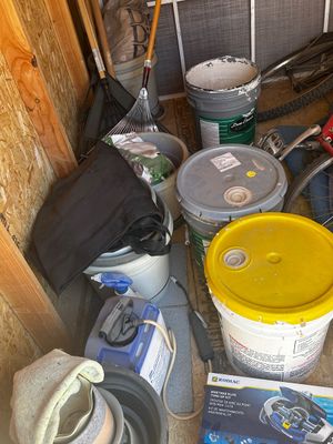 Sale Photo Thumbnail #50: Collection of garden and home maintenance supplies, including paint buckets, rakes, a garden sprayer, and a Zodiac pool tune-up kit.