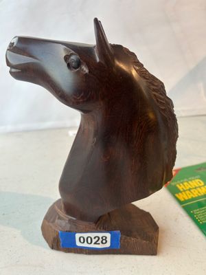 Sale Photo Thumbnail #28: A hand-carved dark wood horse head bust mounted on a integral carved wooden base. Features carved details on the mane, eyes, and muzzle. Shows natural wood grain and minor surface wear consistent with age.