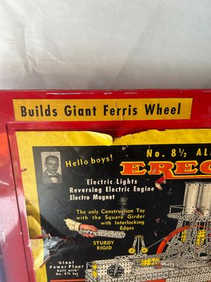 Sale Photo Thumbnail #95: A vintage A.C. Gilbert Erector Set No. 8 1/2 "All-Electric" construction toy set housed in its original red metal carrying case. The set includes various metal girders, plates, wheels, pulleys, and electric motor/engine units along with original lid graph