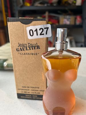 Sale Photo Thumbnail #189: Jean Paul Gaultier "Classique" Eau de Toilette natural spray perfume bottle (100ml / 3.3 fl. oz.) featuring the signature torso-shaped glass bottle design. Comes with its original brown tester box labeled with lot number 0127. Fluid level is nearly full a