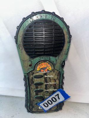 Sale Photo Thumbnail #7: Cass Creek portable handheld electronic game caller featuring a camouflage finish and push-button sound options including MacDaddy, Crow Distress, Crow/Owl Fight, and others. Shows some cosmetic finish wear consistent with field use.