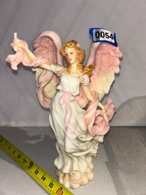 Sale Photo Thumbnail #54: A detailed resin figurine of a winged angel or goddess with strawberry blonde hair, draped in a white gown and flowing pink sash. Features soft pastel hand-painted details, pink feathered wings, and stands on a cloud-like base. Measures approximately 14-1