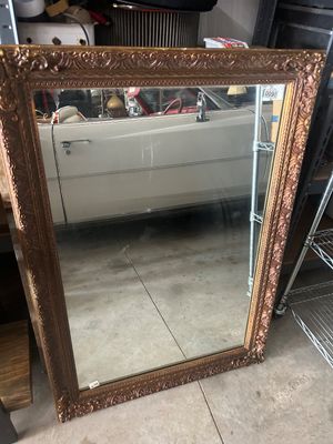 Sale Photo Thumbnail #123: Large vintage wall mirror featuring an ornate, heavily molded composite or wood frame with a gilded bronze/gold-tone finish. Back includes original J.A. Olson Company label marked 'Permaflect Mirror, Winona, Mississippi' with care and hanging instructions
