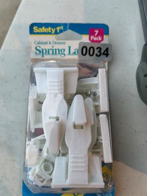 Sale Photo Thumbnail #34: Unopened package of Safety 1st Cabinet & Drawer Spring Latches, containing a set of 7 white plastic child-proofing safety latches. Item No. 10516.