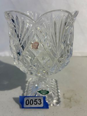 Sale Photo Thumbnail #53: Footed clear cut lead crystal votive or tealight candle holder with a flared tulip-style rim, crosshatch diamond base pattern, and fan detailing on the bowl. Features a square base with decorative edging and original safety caution sticker.