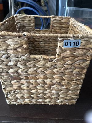 Sale Photo Thumbnail #172: A square woven storage basket featuring built-in side handles and a sturdy metal frame under natural seagrass or water hyacinth weave.