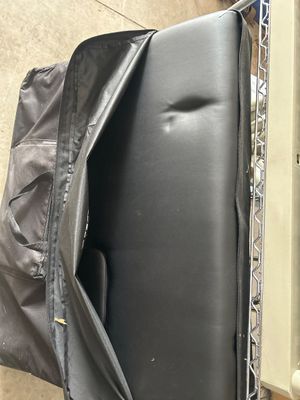Sale Photo Thumbnail #185: A BestMassage portable folding massage table featuring black vinyl upholstery and a heavy-duty black fabric carrying bag with handles and an accessory pocket. Appears lightly used.