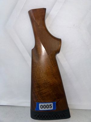 Sale Photo Thumbnail #5: A dark wood replacement rifle or shotgun buttstock featuring checkered grip panels and a fitted black rubber recoil pad. Appears to be in good used condition with nice wood grain.