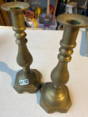 Sale Photo Thumbnail #196: A matching pair of traditional brass candlestick holders featuring baluster-form stems and multi-sided flared bases. Shows light patina and wear consistent with age and use.