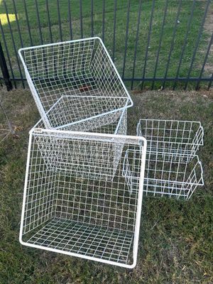 Sale Photo Thumbnail #72: A collection of white vinyl-coated metal wire storage baskets in various sizes. Includes large deep bin-style baskets and smaller stacking or sliding drawer-style baskets. Ideal for closet, pantry, or garage organization. Baskets show light signs of wear 