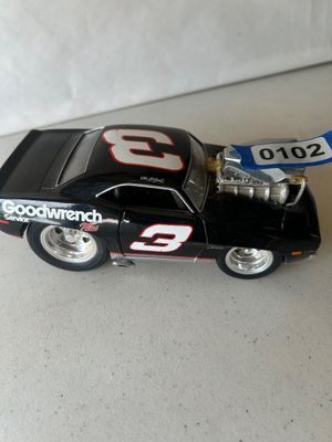 Sale Photo Thumbnail #151: A cartoon/pro-street style die-cast model vehicle featuring Dale Earnhardt #3 GM Goodwrench Service Plus livery on a Chevrolet Camaro Z28. Features an exposed supercharged engine and oversized rear drag tires. Shows minor surface wear consistent with disp
