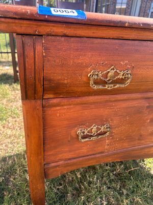 Sale Photo Thumbnail #76: A vintage wooden chest featuring two long drawers with ornate metal brass-tone bail handles, keyhole accents, and French/cabriole style front legs. The surface shows age-appropriate wear, surface scratches, water rings, and finish loss throughout, consist