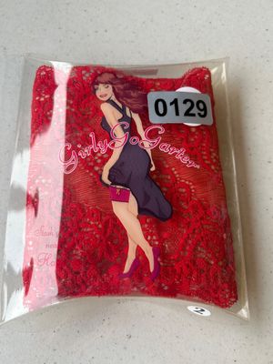 Sale Photo Thumbnail #191: New in original clear plastic box packaging, a GirlyGoGarter red lace storage garter. Designed to securely hold items like phones, keys, or cards under clothing.