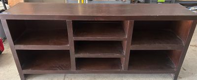 Sale Photo Thumbnail #135: A dark brown wood media console featuring multiple open cubbies and shelves for electronic components and media storage. Tape measure photos show approximate dimensions of 72 inches long, 16 inches deep, and 32 inches high. Shows light surface wear and sc