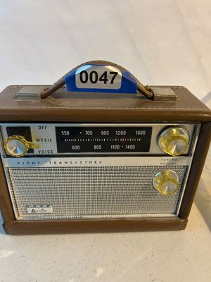 Sale Photo Thumbnail #47: A vintage Arvin 8 transistor portable AM radio clad in a brown faux-leather case with carrying handle. Features clear control knobs for tuning, volume, and Music/Voice selector, alongside a classic AM frequency tuner display.