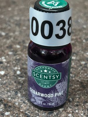 Sale Photo Thumbnail #38: A bottle of Authentic Scentsy fragrance oil in Cedarwood Pine scent. Volume is .5 fl oz (15 ml). Appears unused or lightly used.
