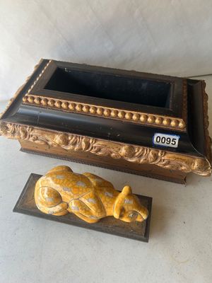 Sale Photo Thumbnail #133: An Art Deco style decorative trinket or keepsake box featuring a reclining yellow crackle-glaze ceramic leopard finial on a lid. The box is constructed of wood with dark finish trim and ornate gilt beaded and carved scroll accents. The lid lifts off to re