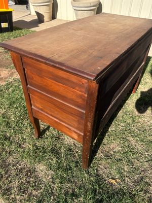 Sale Photo Thumbnail #75: A vintage wooden chest featuring two long drawers with ornate metal brass-tone bail handles, keyhole accents, and French/cabriole style front legs. The surface shows age-appropriate wear, surface scratches, water rings, and finish loss throughout, consist
