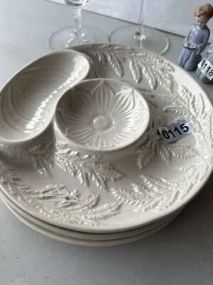 Sale Photo Thumbnail #176: Stack of off-white ceramic divided serving platters featuring an embossed botanical/fern motif and built-in dip bowls. Smooth glossy glaze throughout, appears to be in good pre-owned condition without chips or cracks.