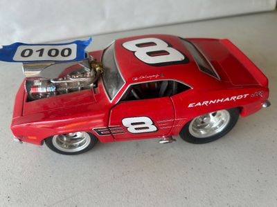 Sale Photo Thumbnail #148: A red custom cartoon-styled/hot rod die-cast model car featuring Dale Earnhardt Jr. #8 graphics, a large exposed blower/engine intake, opening doors, and oversized deep-dish rear wheels. Shows minor wear and dust consistent with display.
